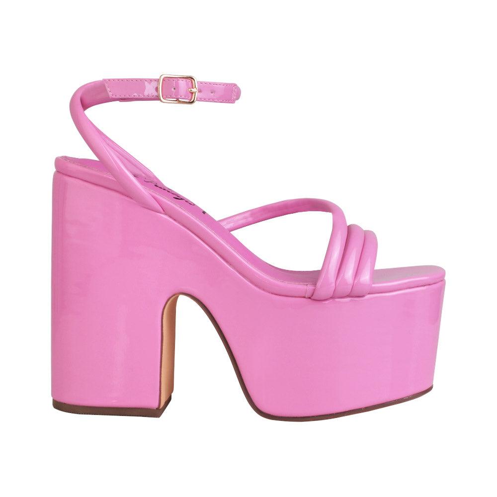 Pink colored women platform heels with ankle buckle closure-side view