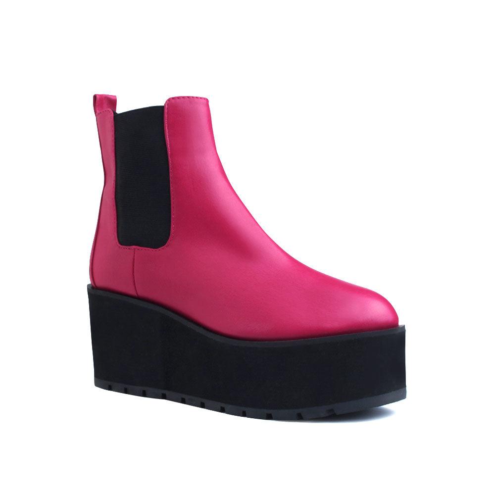 Pink colored women booties with black platform-corner view