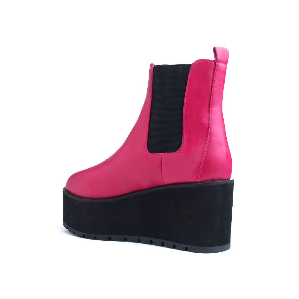 Pink colored women booties with black platform-posterior view