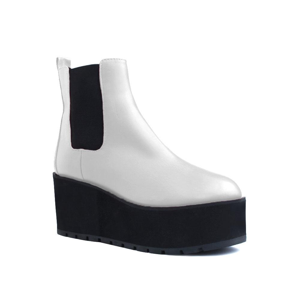 White colored women booties with black platform-corner view