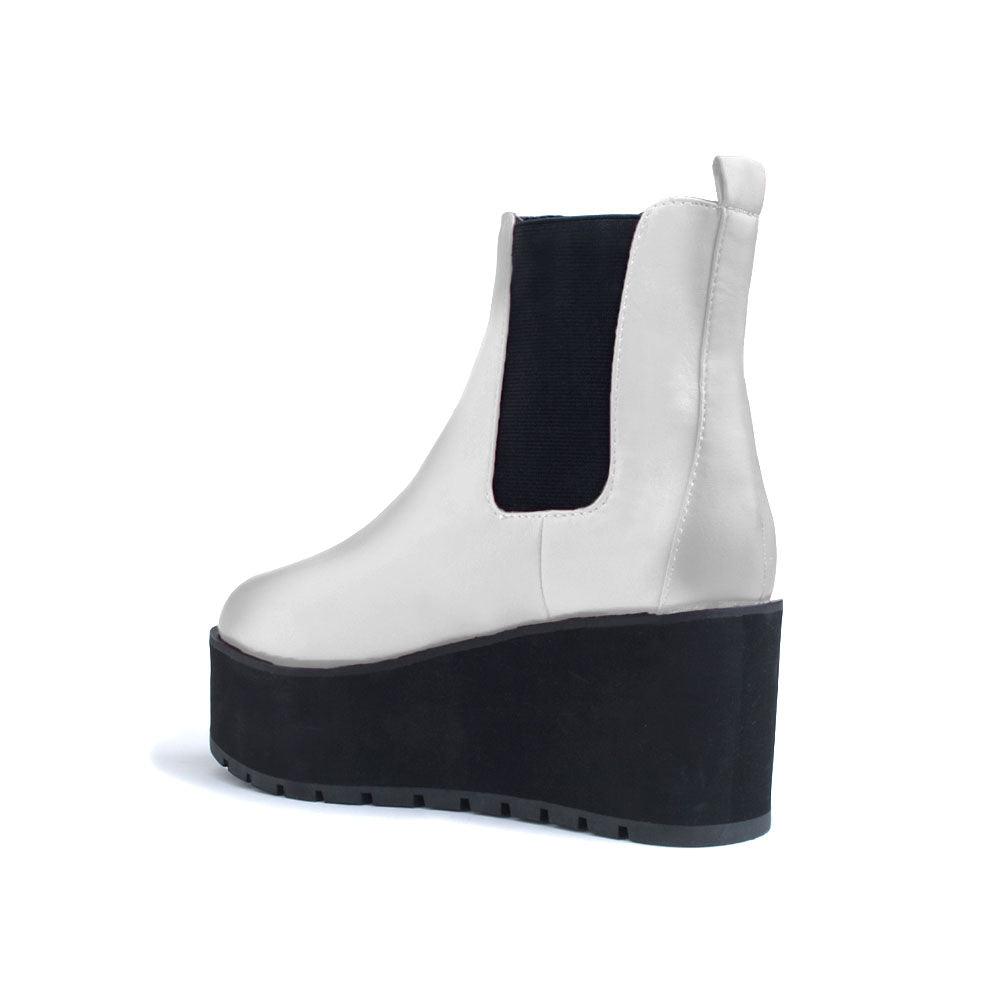 White colored women booties with black platform-posterior view