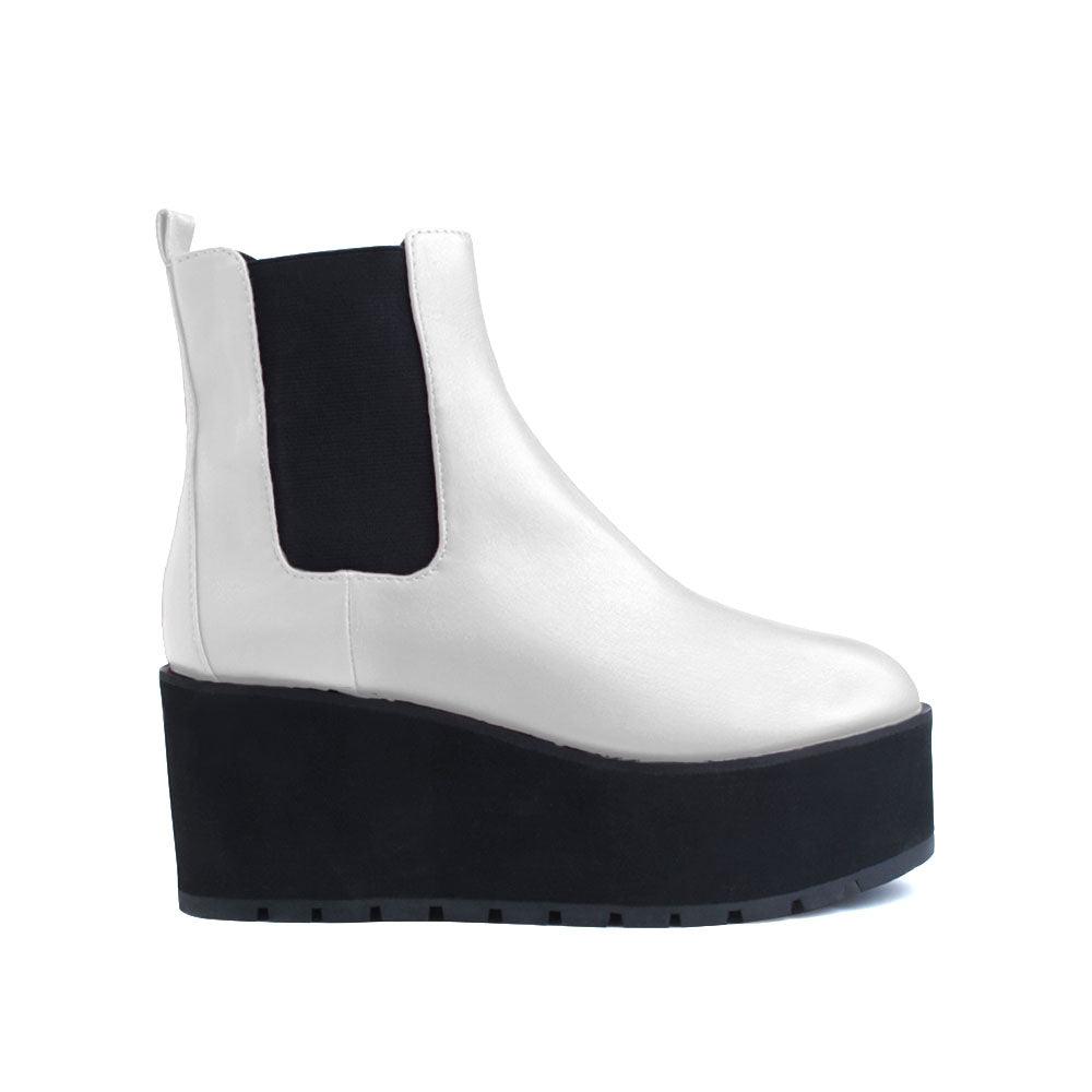 White colored women booties with black platform-side view