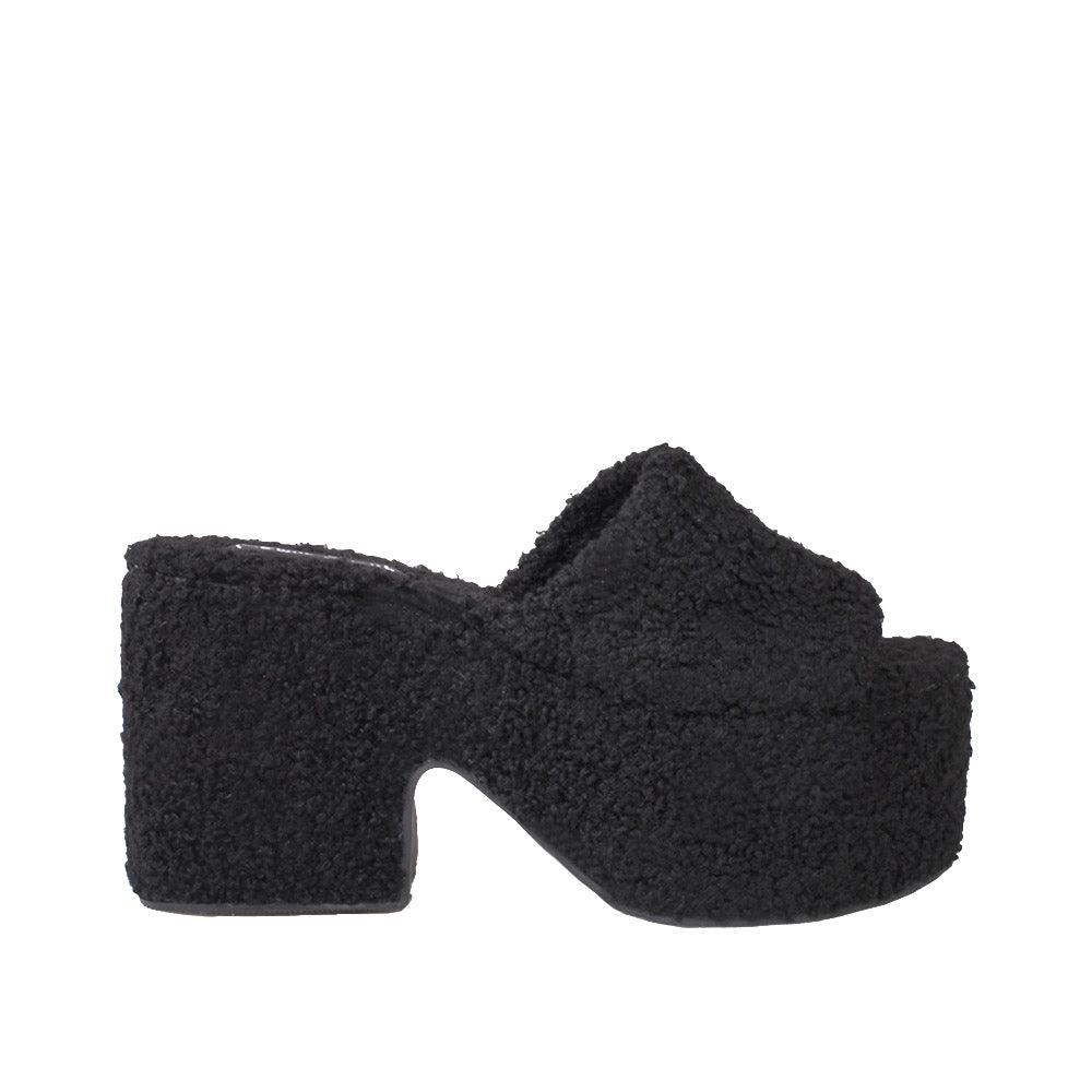 Black platforms with a slip-on design and furry upper