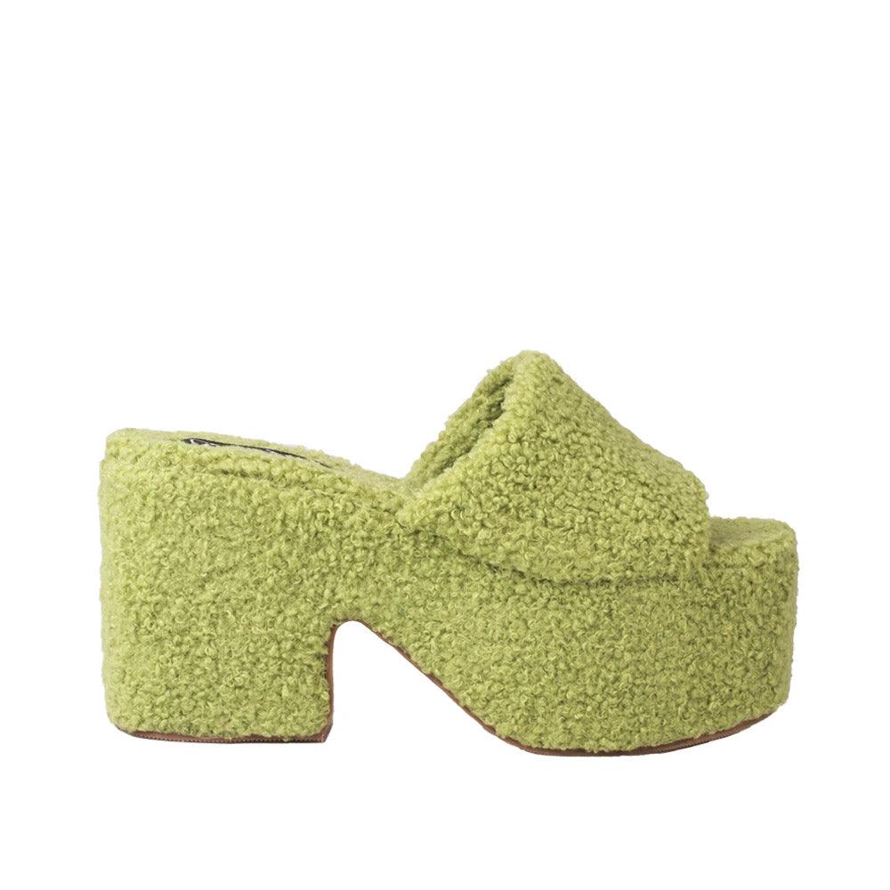 Platforms in green with slip-on style and furry top.