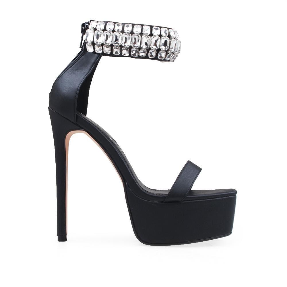 Platform heels in black with gem-encrusted ankle cuff and back zip closure.