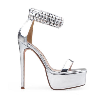 Silver colored platform heels with gem embellished ankle cuff and back zipper closure