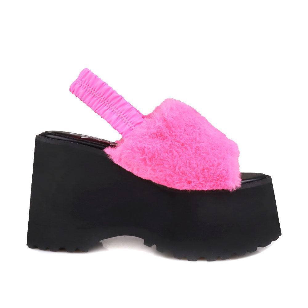 Black colored platforms with pink fur upper and slip on design