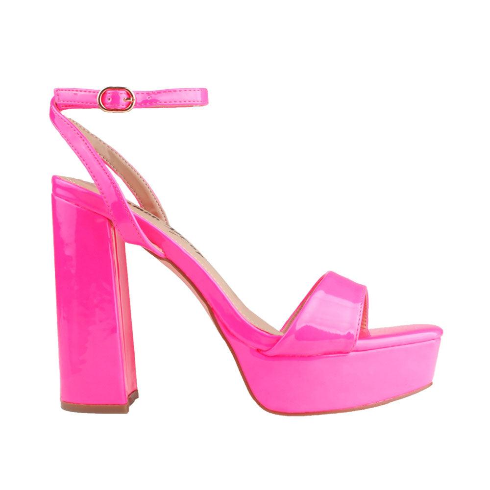 Fuchsia-colored platforms with block heels and an ankle buckle clasp.