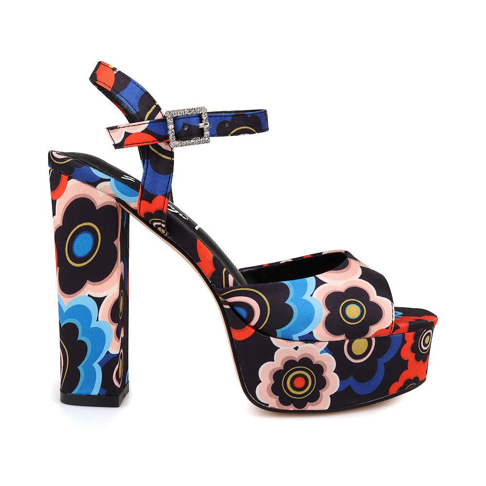 Women's platform heels featuring black-multi textile upper and ankle buckle fastening.