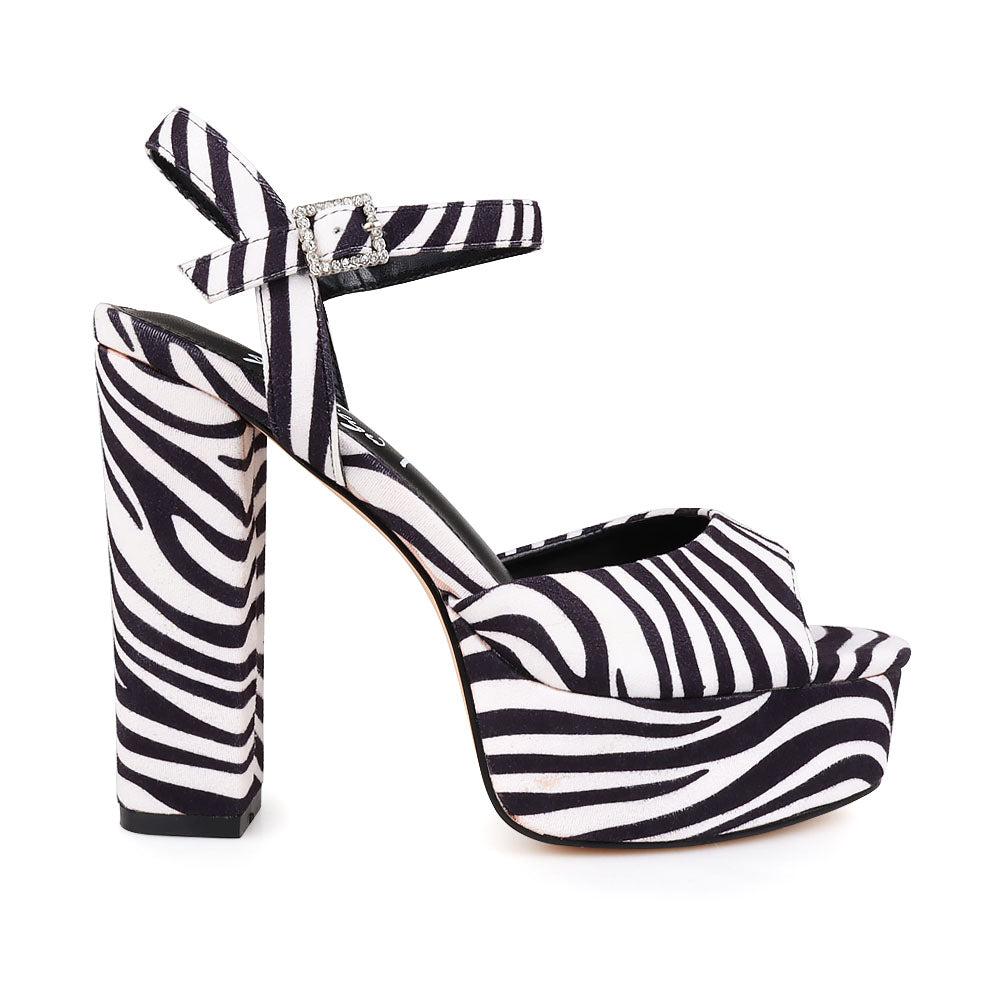 Platform heels for women featuring zebra pattern design and an ankle buckle fastening.