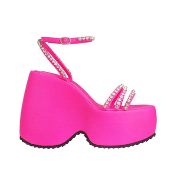 Platforms in pink with ankle buckle clasp and multiple straps decorated with gems 