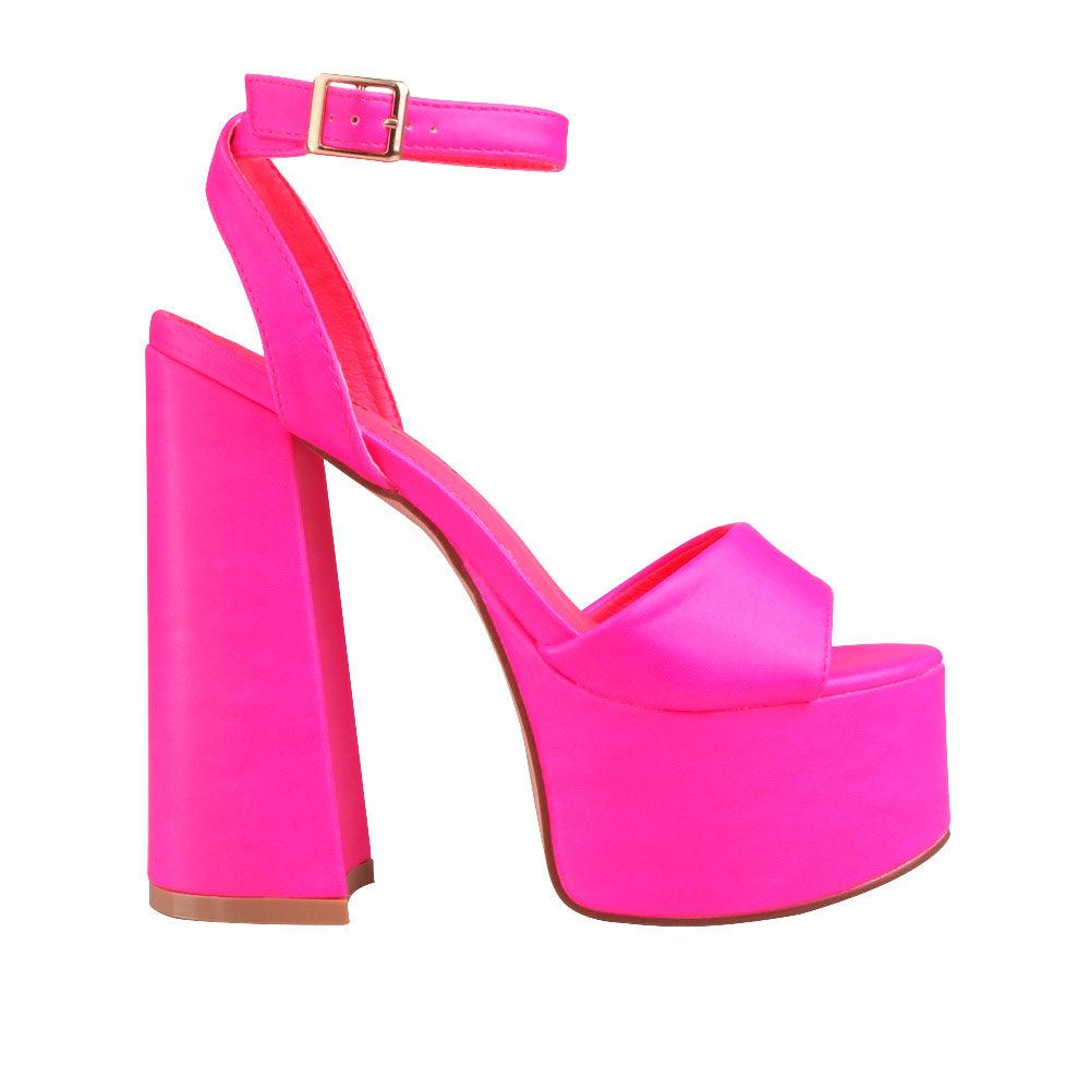 Neon pink slip-on platform heels with ankle buckle clasp. and open toe