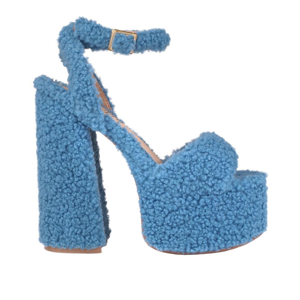 Shag covered women's platform heels in blue-side view