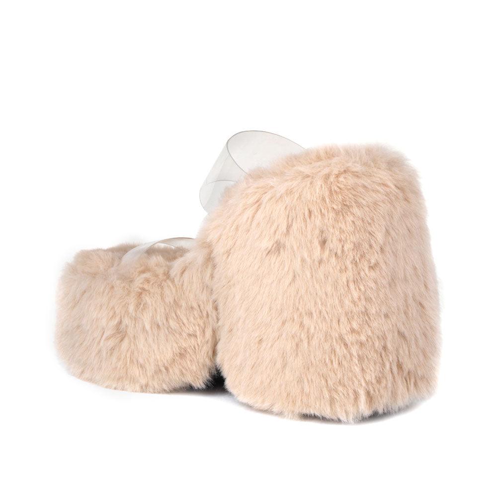 Vinyl upper women's nude wedge slip ons covered in fur-posterior view