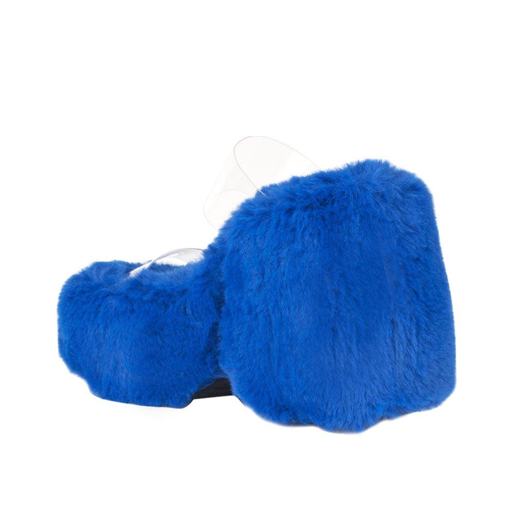 Vinyl upper women's cobalt wedge slip ons covered in fur-posterior view