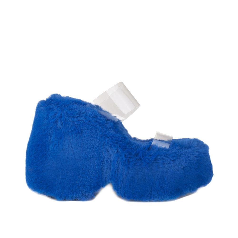 Vinyl upper women's cobalt wedge slip ons covered in fur-side view