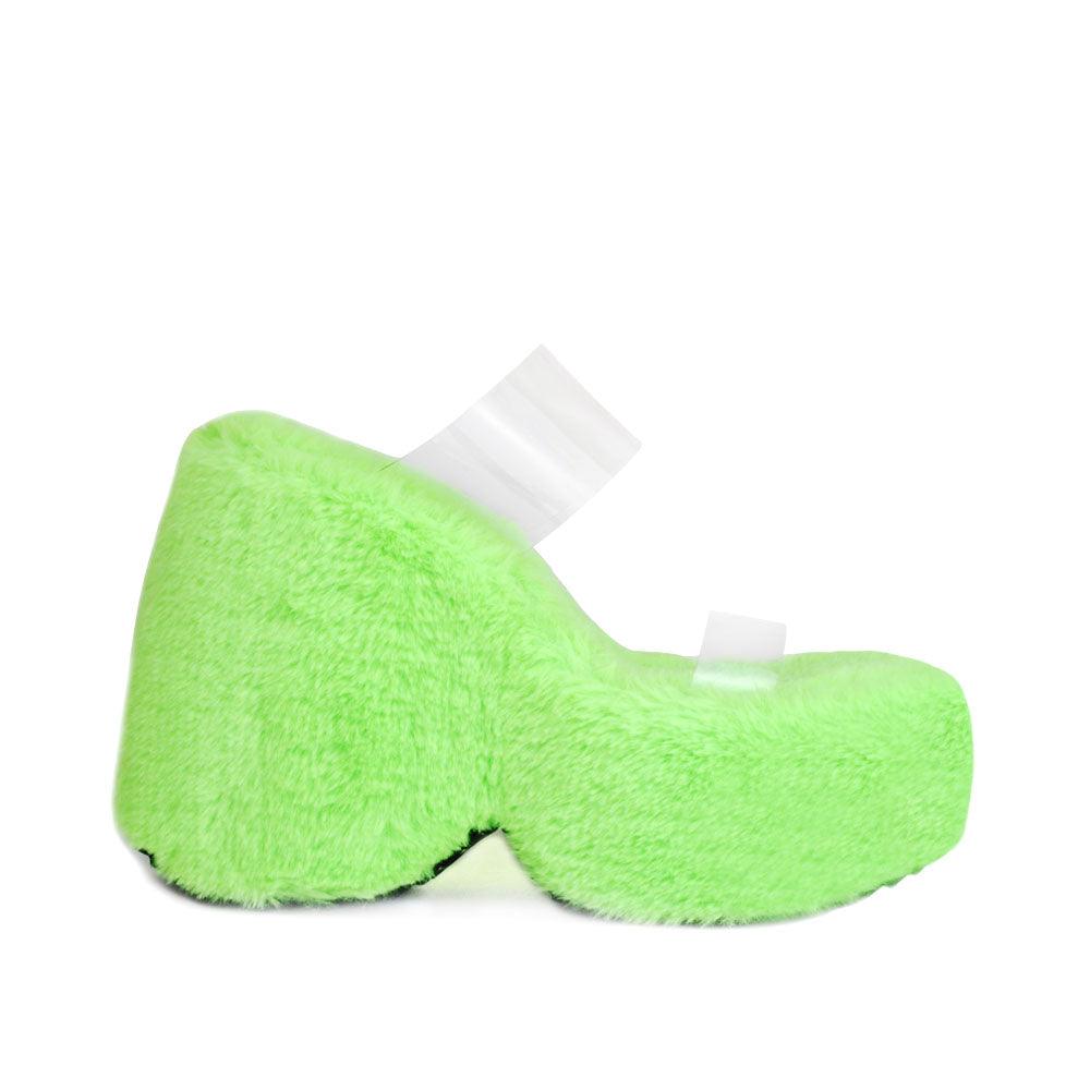 Vinyl upper women's neon green wedge slip ons covered in fur-side view