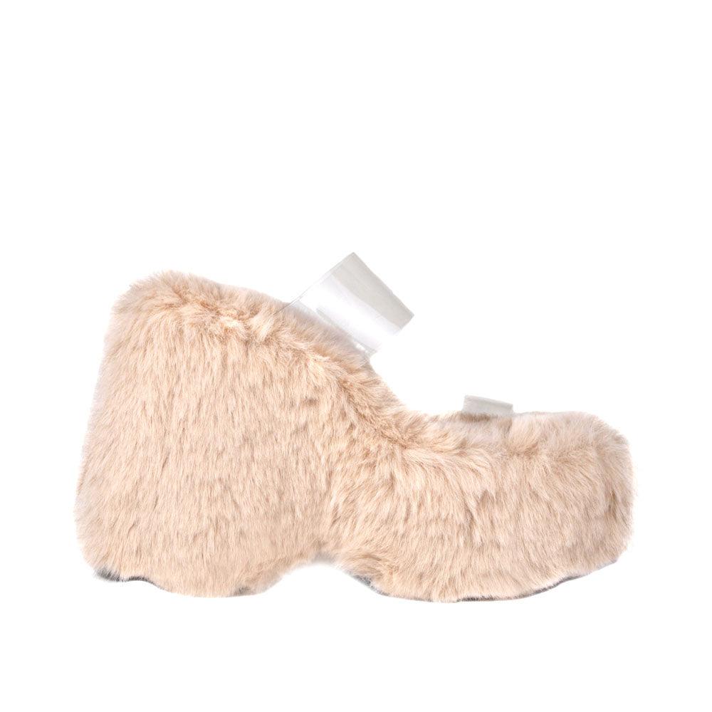 Vinyl upper women's nude wedge slip ons covered in fur-side view