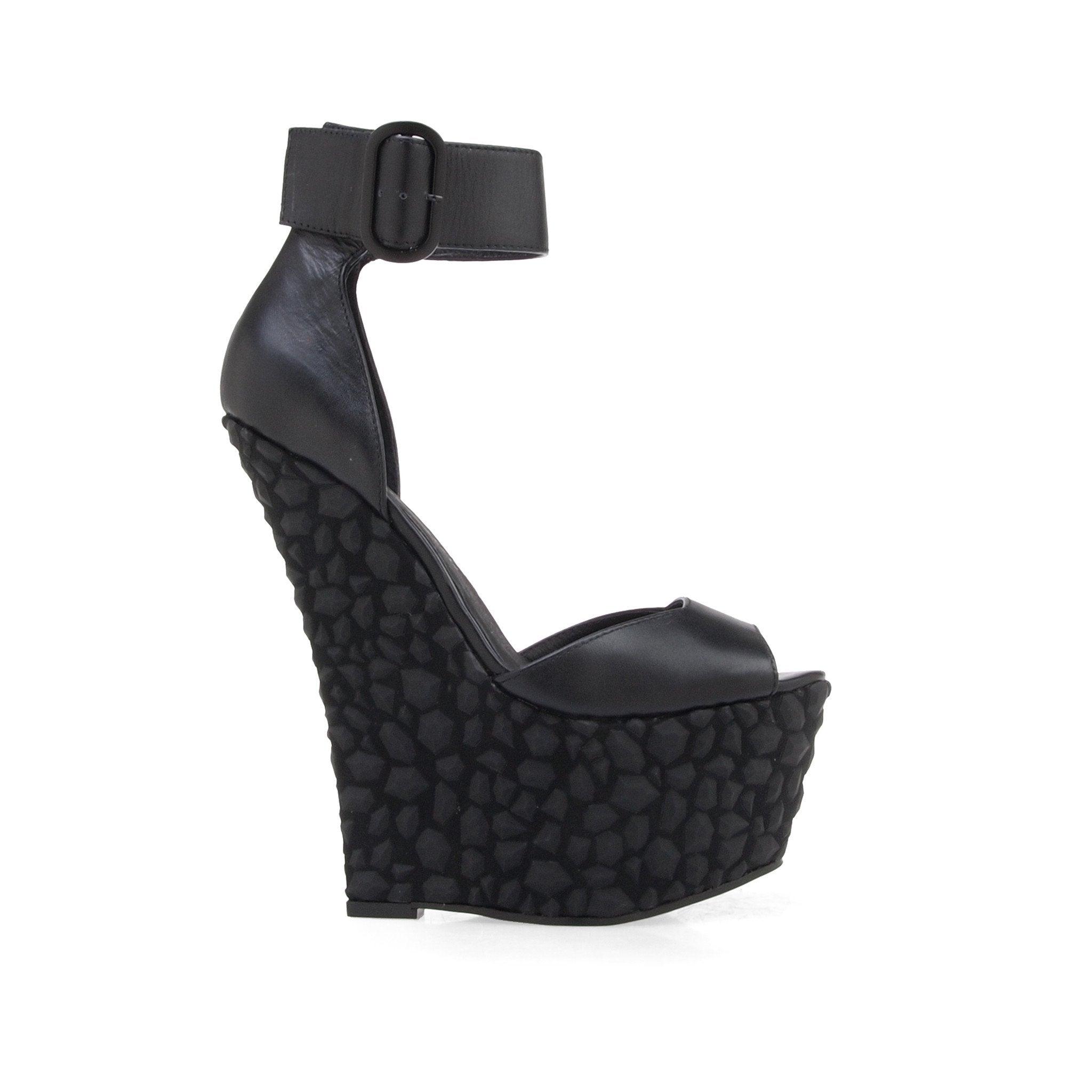 Leather wedge women's heel in black-side view