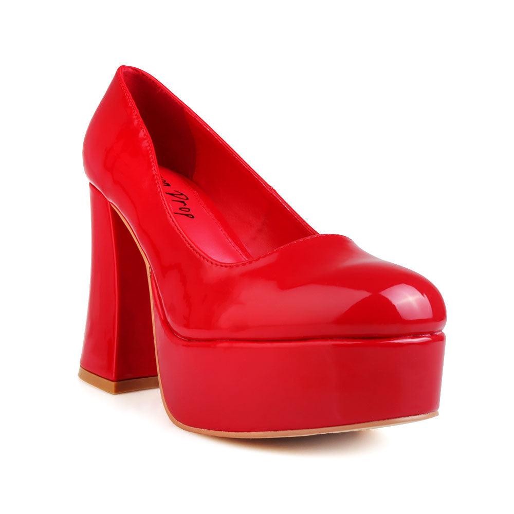 Red women pumps with platform heel-corner view