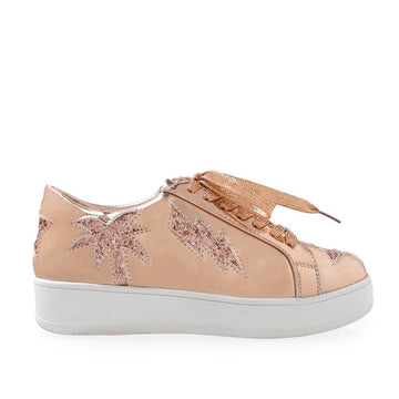Golden-colored women's sneaker with lace up front and glitter accent