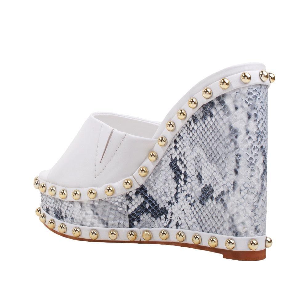 Metallic studded white and black wedge shoes for women with a white top-posterior view