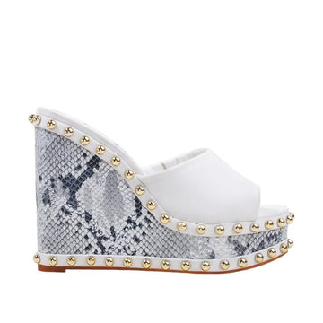 Metallic studded white and black wedge shoes for women with a white top-side view