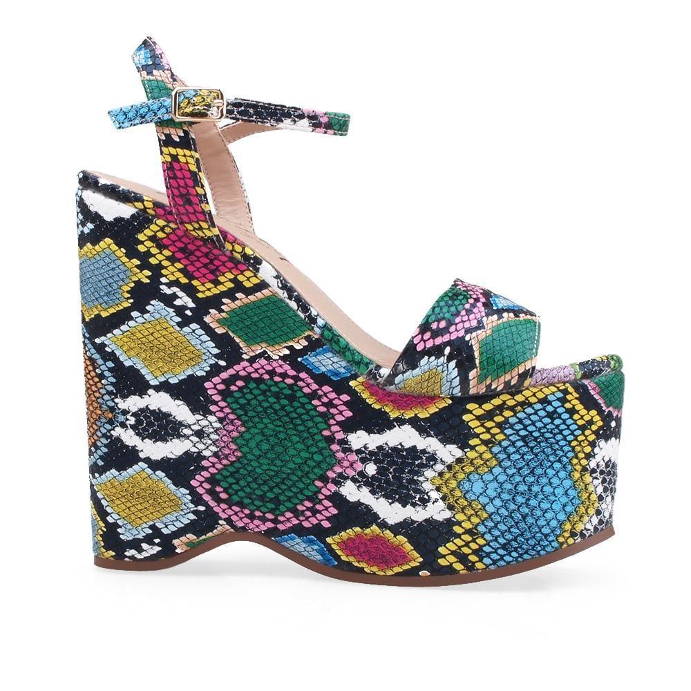 Wedge shoes with multi-snake pattern and an ankle buckle clasp.