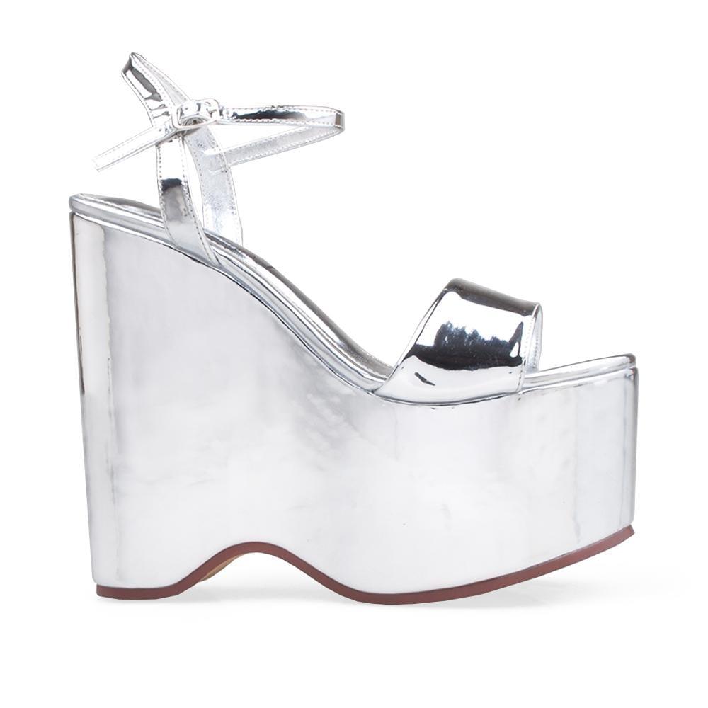 Wedge shoes in silver with slip-on style and ankle buckle clasp.