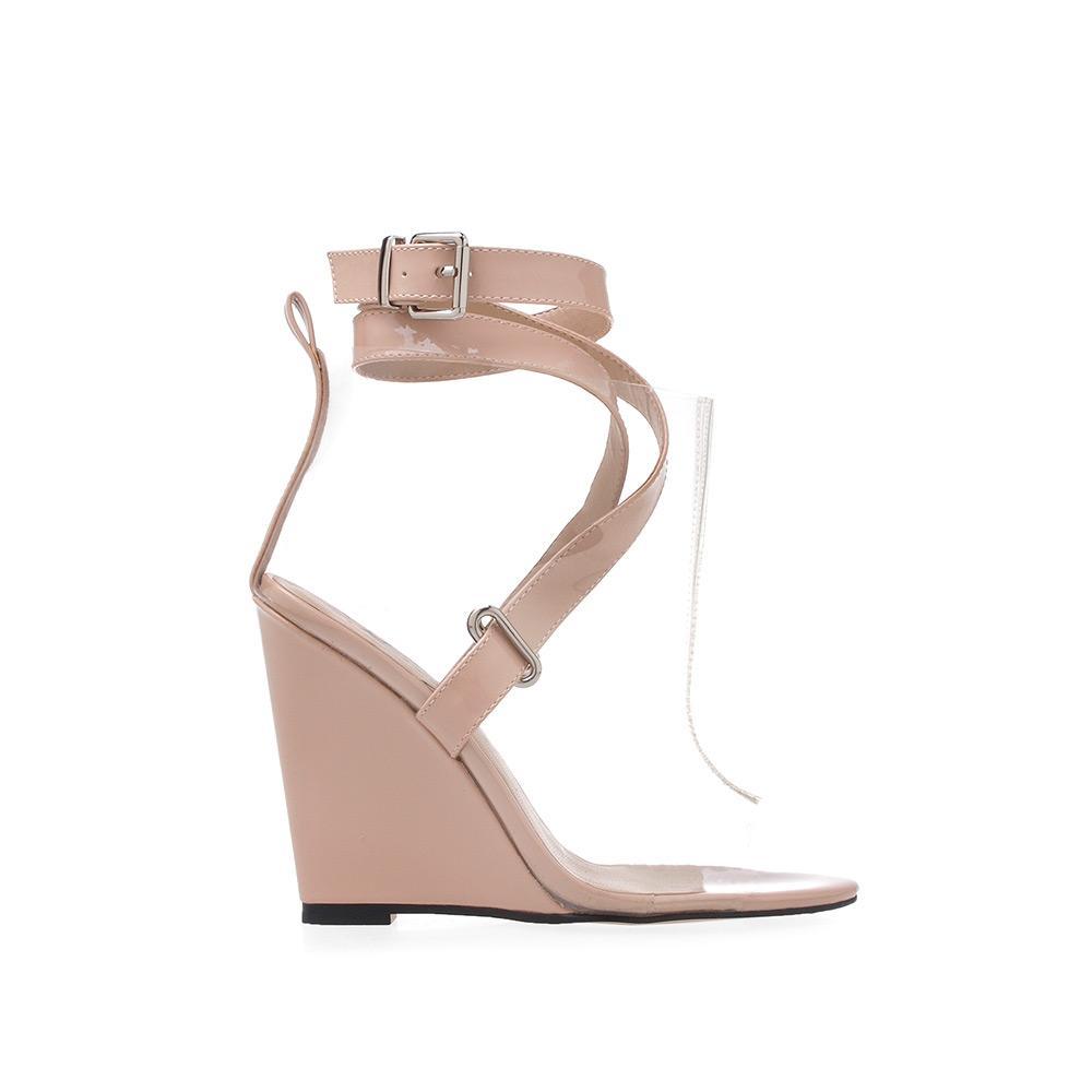 Nude wedge shoes with symmetrical strap design and clear upper with ankle buckle closure 